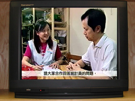 Census officer interviewing household member.