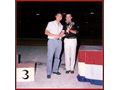 Dr. R Butler, Commissioner (right), presenting a trophy to the representative of the winning Division of the Departmental Sports Day in 1986.