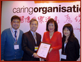 A photo with the guest, Dr. Rosanna Wong, when receiving the “Caring Organisation Logo” awarded by the Hong Kong Council of Social Service in 2009.